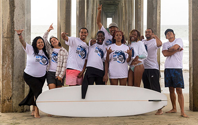 Black Surf Week participants gather on the beach for a group photo. Photos by Erik Jepsen/UC San Diego